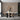 Abstract wall mural in muted earth tones with arches, flowing lines, and botanical shapes behind a round dining table and five chairs.