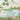 Tranquil wallpaper featuring a blue stream, vibrant flowers, butterflies, dragonfly, green trees and distant pink mountains.