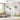 Whimsical mural wallpaper with tall leafy trees, birds, and pastel clouds adds dreamy charm to a sunlit living room with large window.