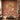 Wall mural with lush palms, graceful birds, cows, and lotuses in earthy hues sets a traditional Indian tone in a cozy living room.