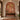 Wall mural in a hallway features birds, leafy branches, and a cow within an arched niche; paired with wooden console, gold lanterns, marble floors.