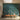 Sunlit room with a custom teal wallpaper featuring flamingos, lotus flowers, lily pads, and distant cityscape behind a wooden bench.