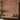 Wallpaper with beige trees and starbursts on dusty pink sets a calm tone, paired with a wooden bench and potted plants in the corner.