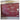 Maroon wallpaper with bold white floral outlines creates a striking pattern above a gray floor, accented by subtle outlets and an air conditioner.