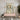 Abstract painting on a neutral wall above a blush pink console, accented by gold sconces and contemporary sculptural decor in a modern entryway.