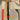 Modern wallpaper with geometric watercolor shapes in soft beige, gray, red, black, and yellow. Yellow circle and rectangles create a balanced, artistic wall design.