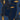 Dark blue wallpaper with graceful gold outlines forms overlapping faces, eyes, and organic shapes, adding a mysterious layered effect to the room.