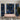Blue and gold abstract face mural adds artistic flair to a contemporary room, paired with a light pink console table and potted greenery.