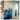 Abstract blue and gold mountain mural adds a modern touch to a light-toned room, with shelving and exposed outlets on the wall.