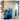 Abstract blue and gold wave mural flows across a modern interior wall, contrasted by visible electrical panels and unfinished floors.