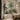 Tropical mural wallpaper with lush palm trees and birds accents a modern bathroom, gold fixtures, warm lighting and elegant decor.