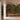 Hand-painted wallpaper with lush green trees, blooming plants, and birds behind a wooden bench on marble flooring.