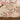 Delicate pink cherry blossom branches and green leaves pattern a beige, textured wallpaper above grassy patches and small blooms.