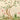 Twisted tree with lush green leaves and pink blossoms, buzzing bees, and blooming plants set against a soft beige hilly backdrop.