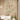 Sunlit beige room with textured curtains, nature-themed mural wallpaper, vases, and books atop a compact accent table.