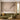 Green velvet sofa and gold pillow in a bright living room, with floral branch wallpaper, bird mural, and soft natural lighting.