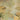 Misty wallpaper design featuring two peacocks on golden branches, a green bird soaring, lush greens, and scattered white flowers.