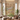 Large mural wallpaper features graceful women dancing amid cows and water, intricate palatial buildings, and sunlit modern living room decor.