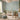 Floral mural wallpaper in soft hues adorns a tranquil nursery, paired with a wooden crib, cozy chair, and sunlight-filtered space.