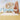 Noah‚Äôs Ark wall mural featuring friendly animals sets a whimsical tone in a nursery with soft peach accents and cozy, playful decor.