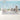 Ocean-themed wallpaper with playful whales, colorful fish, and submarines on a soft blue wall in a kids‚Äô playroom with plush toys.