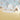 Light blue kids‚Äô room wallpaper with whimsical hot air balloons, clouds, and pastel bunting behind a teepee and soft plush decor.