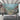 Colorful underwater mural with vibrant fish, coral, and sea plants adds a lively accent wall to a modern living room with gray sofa and wicker chair.