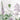 Delicate wildflowers and leafy branches in muted purple, green, and white tones form a soft, elegant pattern on a pale wallpaper backdrop.