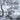 Monochrome mural wallpaper showing a serene rural landscape of trees, village homes, grazing cows and villagers walking among lush foliage.