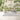 Woodland animal-themed wallpaper with soft gray, beige, and green hues features playful forest creatures, creating a gentle nursery atmosphere.