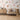 Sea-themed wallpaper with illustrated coral, fish, turtles, and seahorses sets a gentle mood behind a modern wooden dresser and round crib.