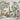 Jungle-themed nursery mural with a gentle palette, depicting giraffe, lemurs, tiger, leafy trees and birds; plush toys and wooden shelves below.