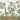 Tropical wallpaper with a graceful giraffe reaching for tree branches, lush green foliage, a perched lemur, and birds soaring overhead.