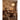 Stylized figures and lush foliage pattern the warm-toned wall mural, set behind a dark wood dining table and upholstered chairs in a cozy room.