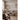 Abstract mural wallpaper in a beige living room, featuring soft, painterly brushstrokes of muted grey and taupe behind a linen sofa.
