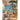 Whimsical wall mural featuring a multi-level treehouse on a seaside cliff, styled in a cozy play area with a rug and wooden toys.