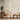 Nature-inspired wallpaper with delicate birds, branches and berries behind two wooden chairs, round table and neutral rug.